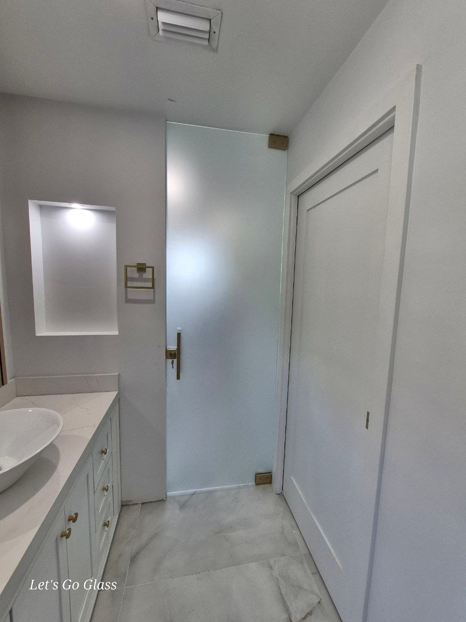 Frosted interior glass door installed by Let's Go Glass